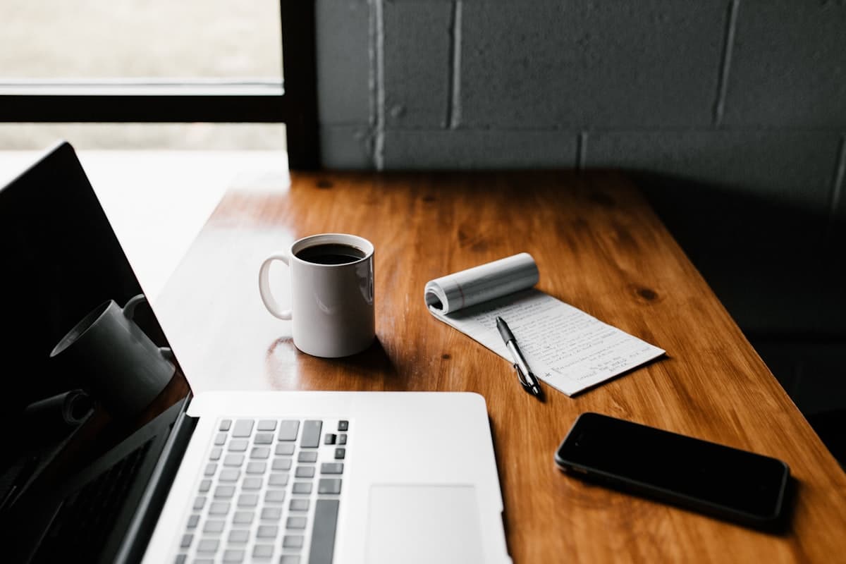 Laptop and coffee on a clean office desk representing small business admin work