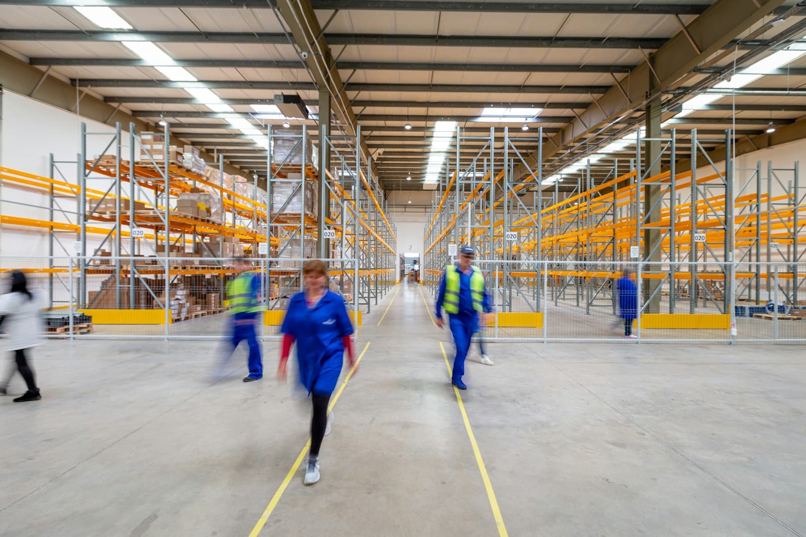 Warehouse team moving through aisles between storage racks