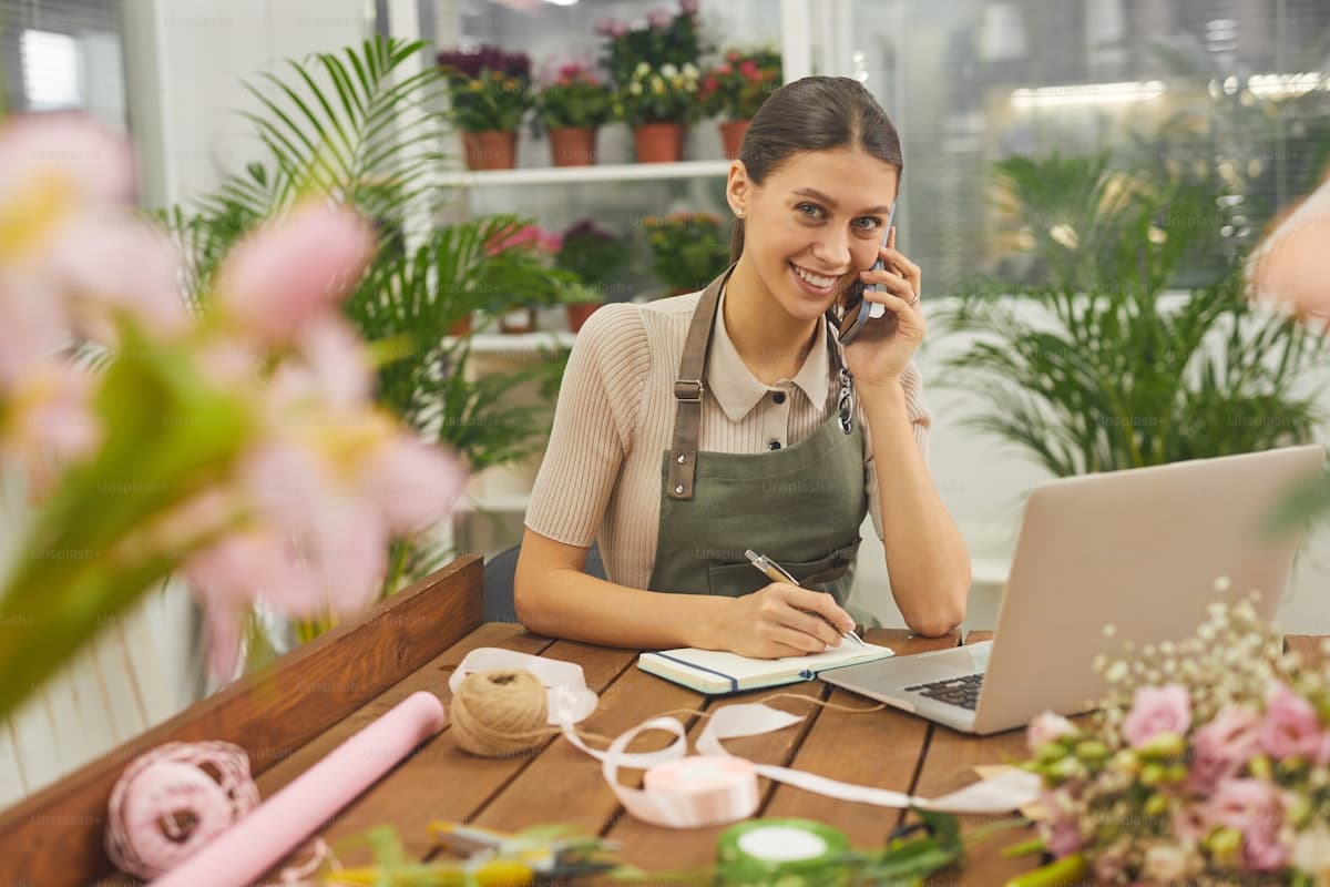Small business owner working from a laptop beside a shop counter